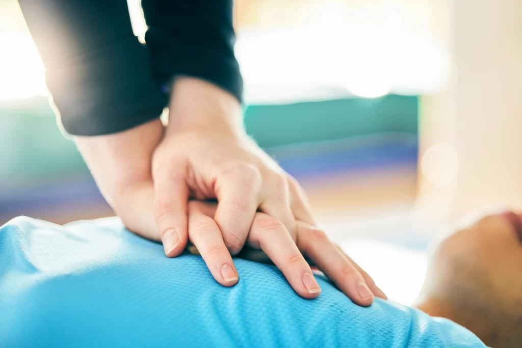 Member of staff performing CPR on a college