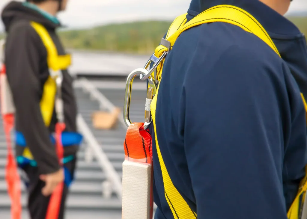 A worker wearing a harness & lanyard